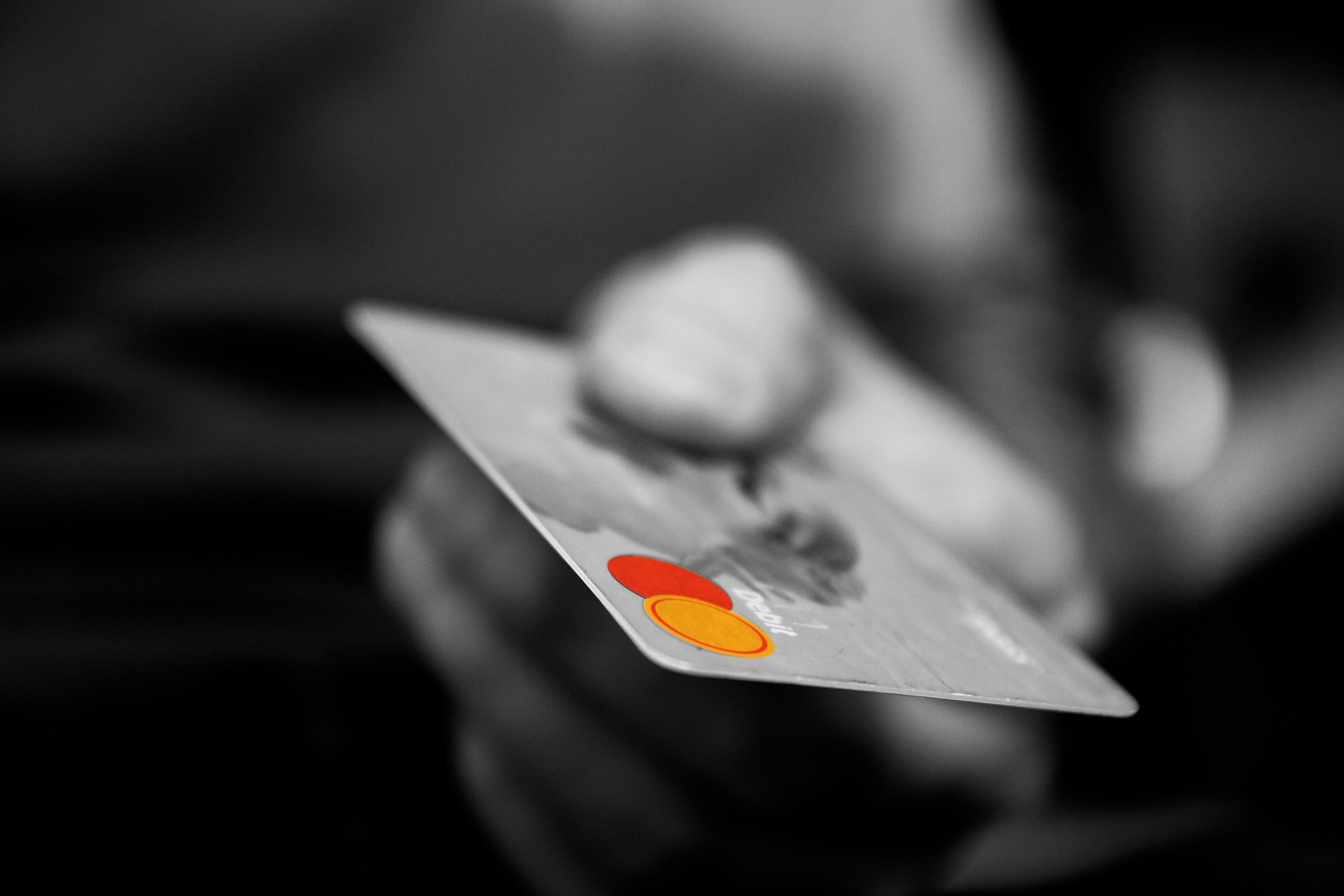 Person holding a credit card. Post about credit card fraud and ecommerce security Person holding a credit card. Post about credit card fraud and ecommerce security